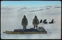 Image of Two Eskimos [Inuit] with Dog Team in Baffin Land